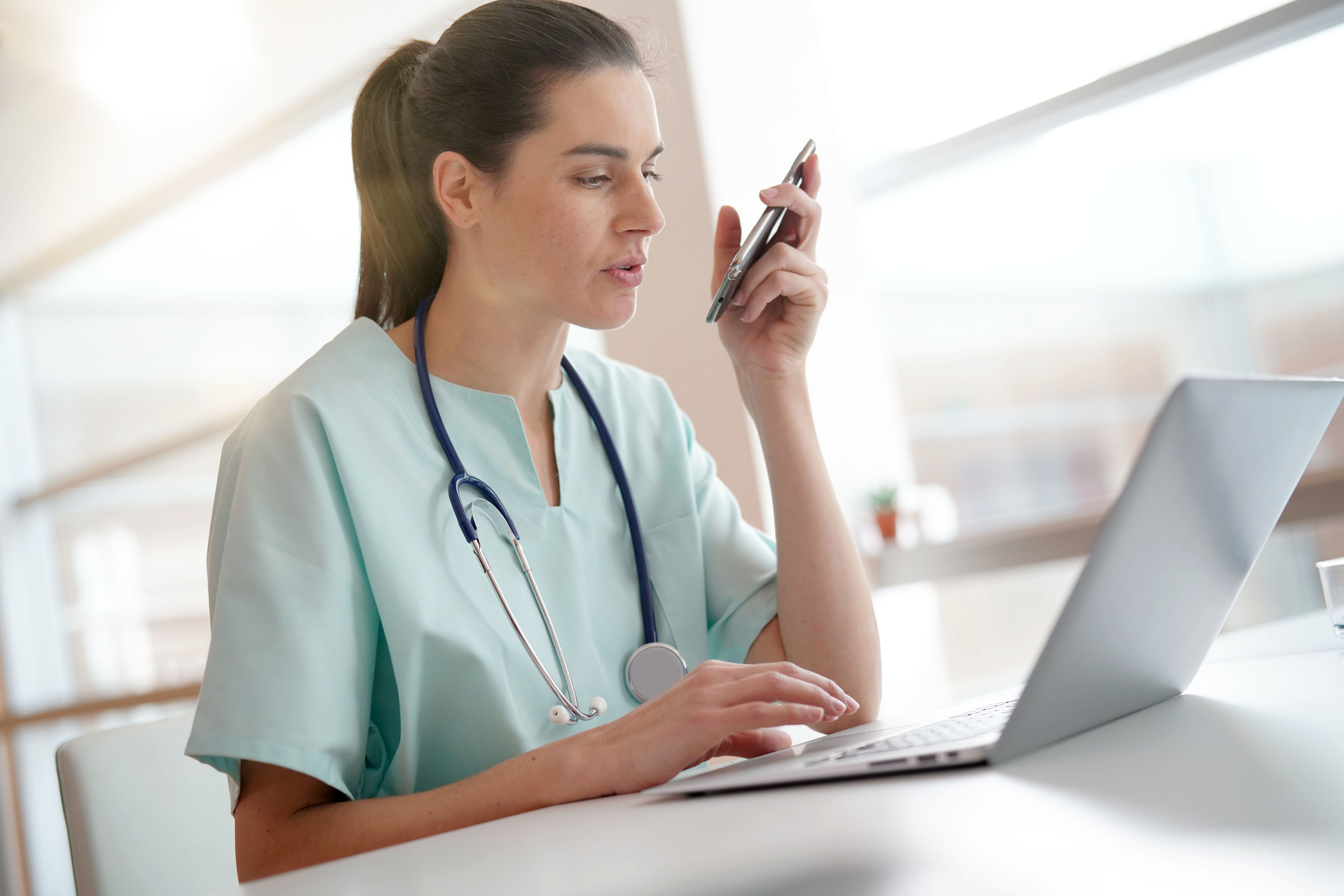 female-doctor-at-desk-with-laptop